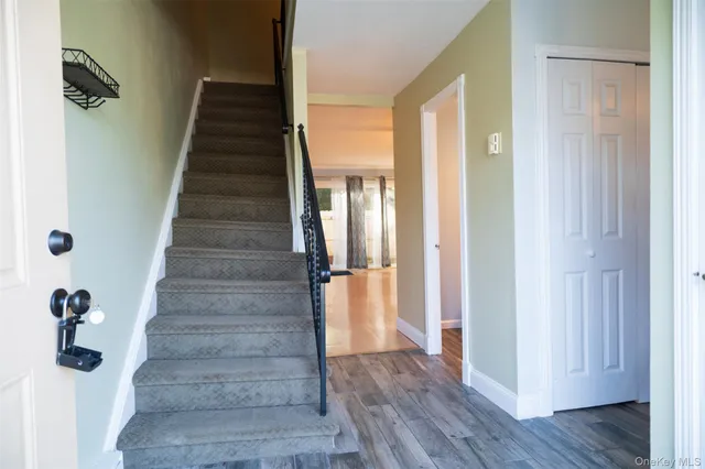 a view of a hallway with wooden floor and entryway