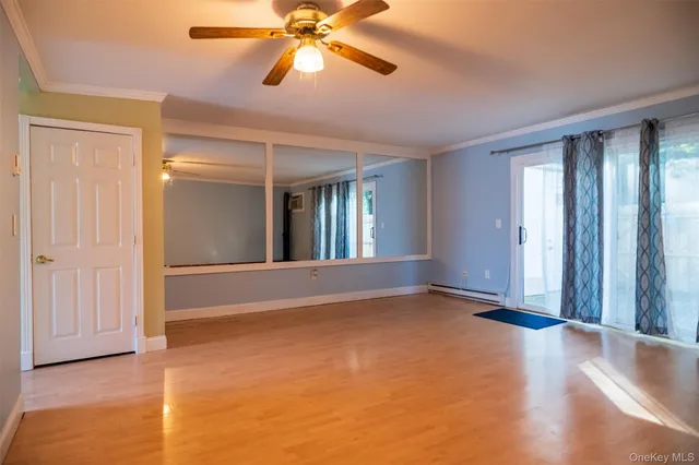 wooden floor in an empty room with a window
