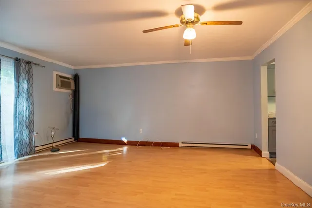 an empty room with closet and fan