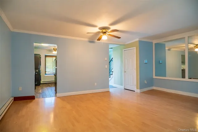 an empty room with closet and a chandelier fan