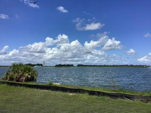 a view of a street sign on a wall next to a lake