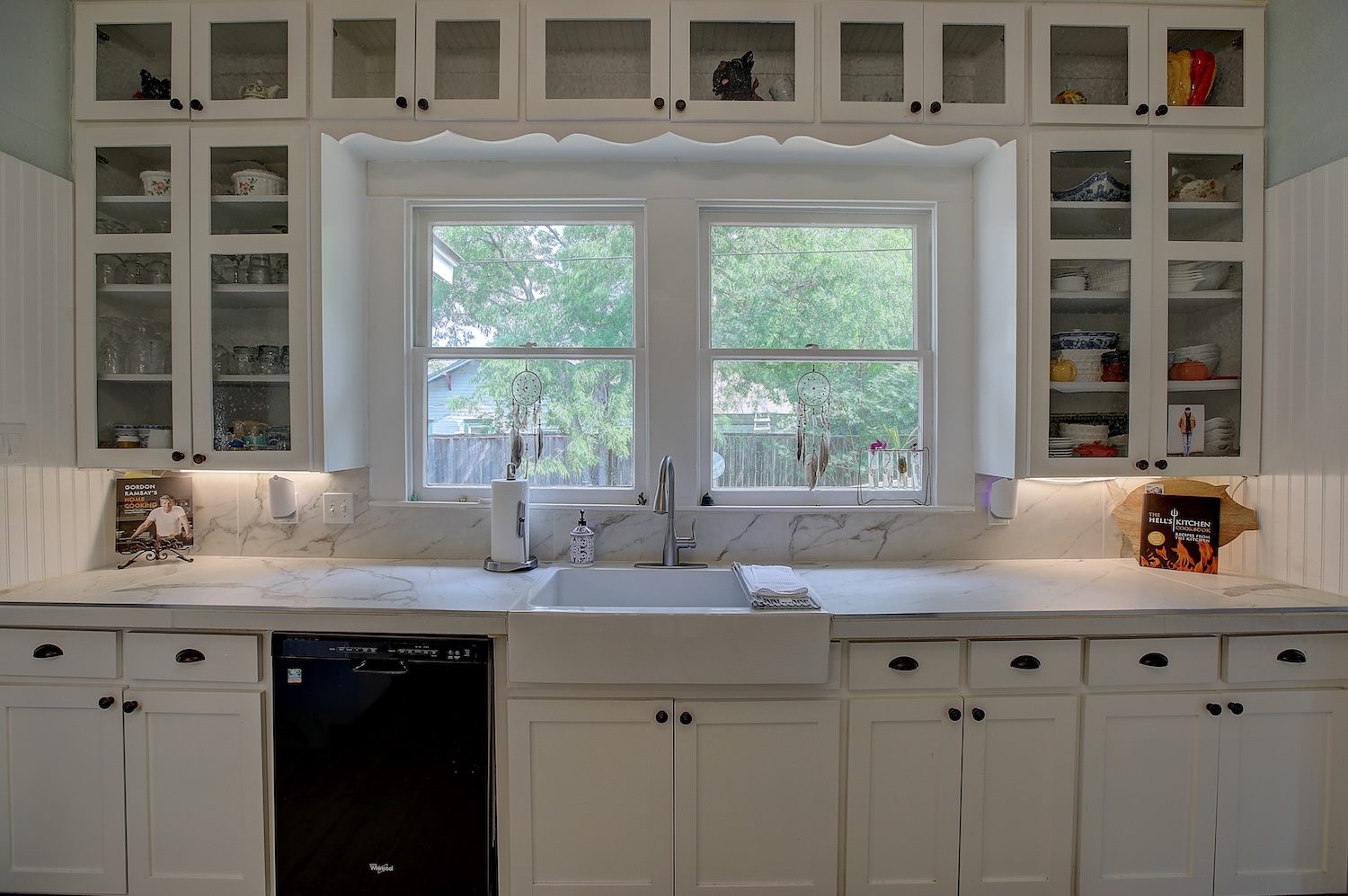 1903 South Austin Avenue Georgetown, TX 78626 - Photo 19 of 40 Updated and yet preserved. These glass front cabinets will show your pretty crockery, while plenty of lower cabinets for pots and pans, etc. You can cook up some pretty good vittles with under cabinet lighting and a pretty view.