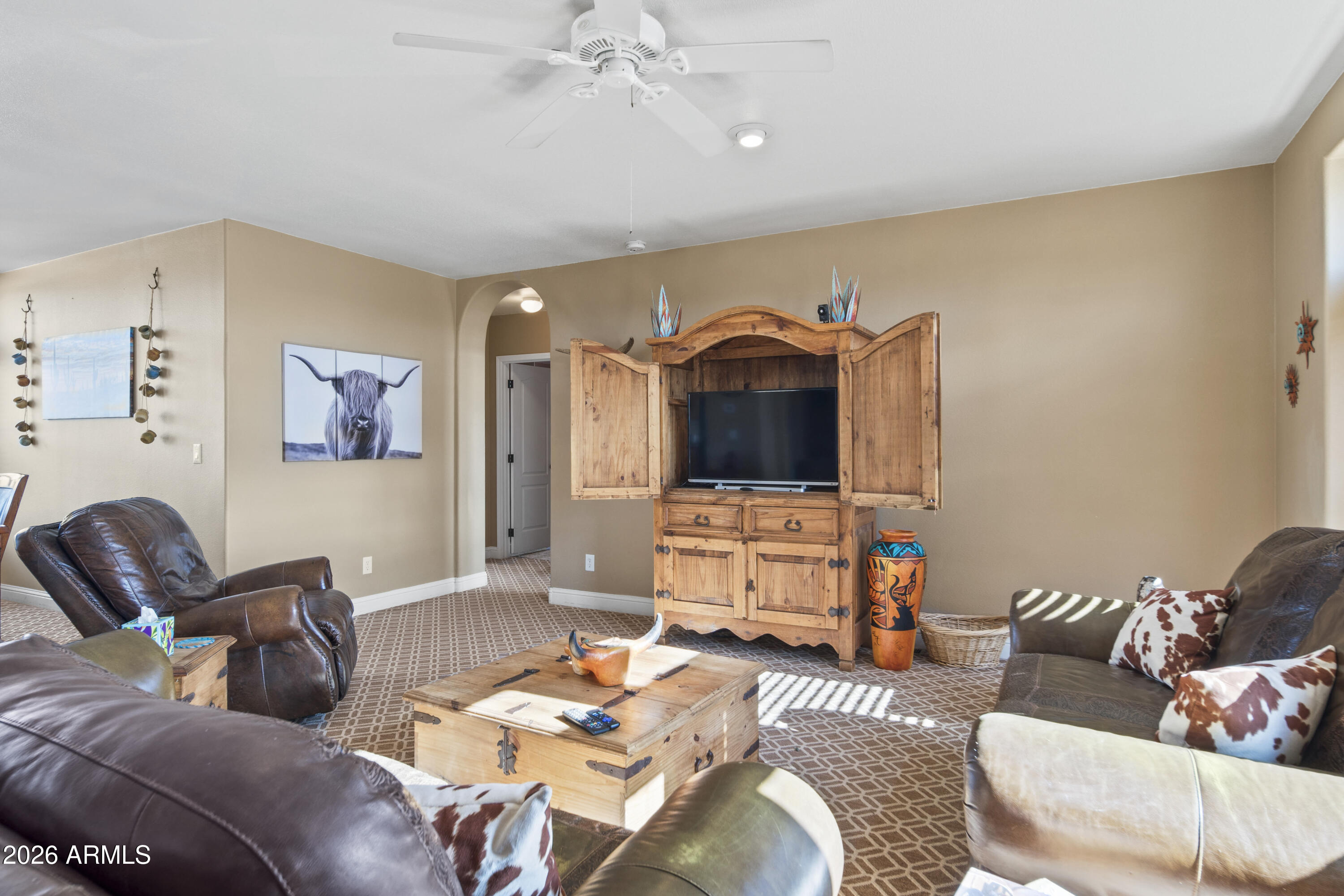 46109 West J-1 Ranch Road Wickenburg, AZ 85390 - Photo 11 of 32 a living room with furniture and a flat screen tv