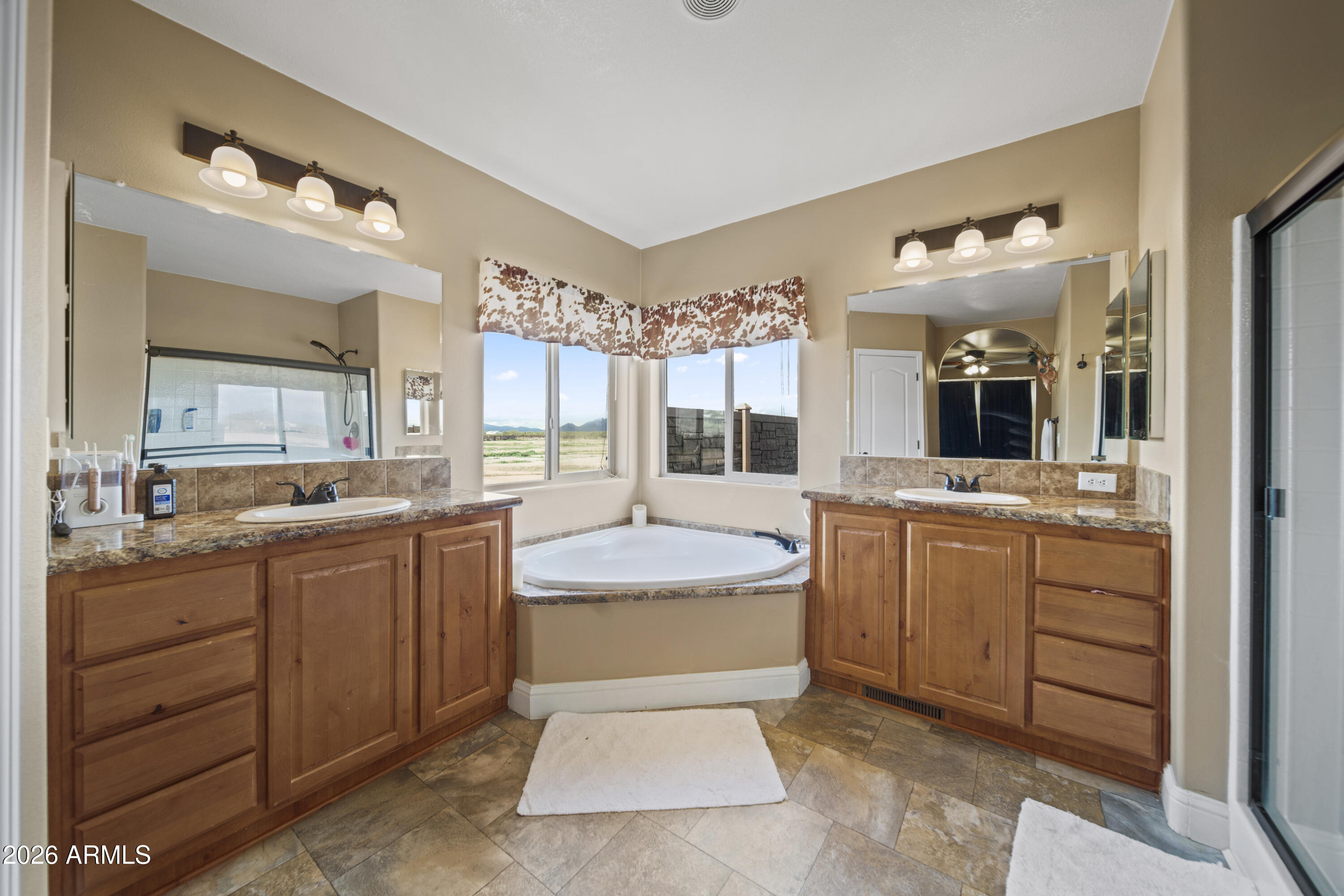 46109 West J-1 Ranch Road Wickenburg, AZ 85390 - Photo 21 of 32 a spacious bathroom with a granite countertop sink mirror and bathtub
