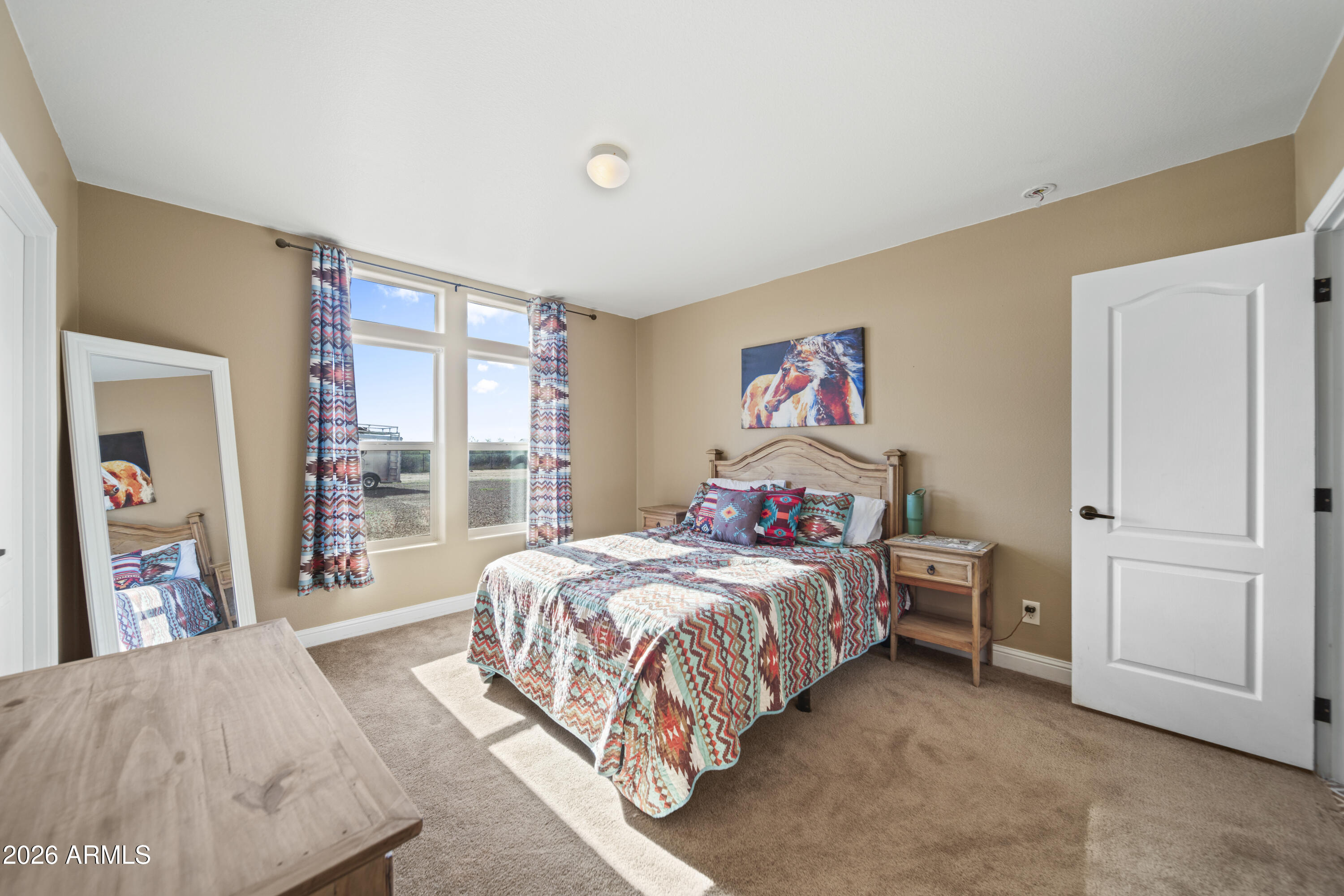 46109 West J-1 Ranch Road Wickenburg, AZ 85390 - Photo 22 of 32 a bed room with a bed and a large window