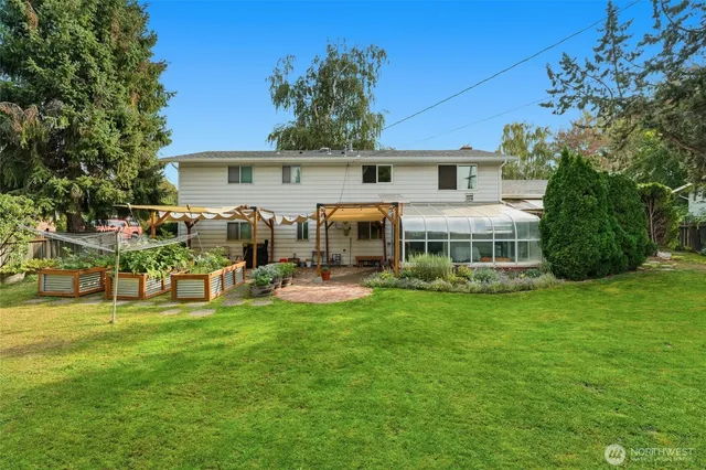a front view of house with yard and outdoor seating