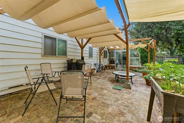 a view of a patio with table and chairs and potted plants