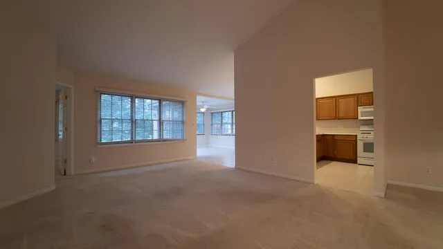 an empty room with windows and entrance