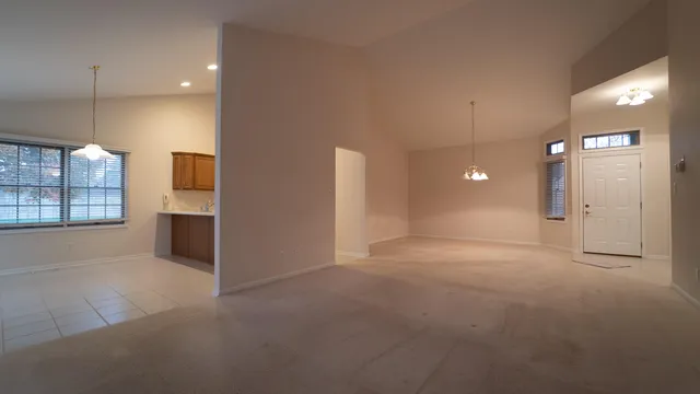 a view of an empty room with a kitchen