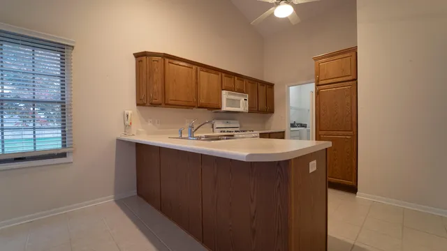 a kitchen with stainless steel appliances granite countertop a sink and a microwave