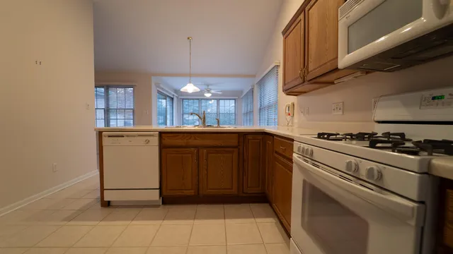 a kitchen with a sink cabinets and appliances