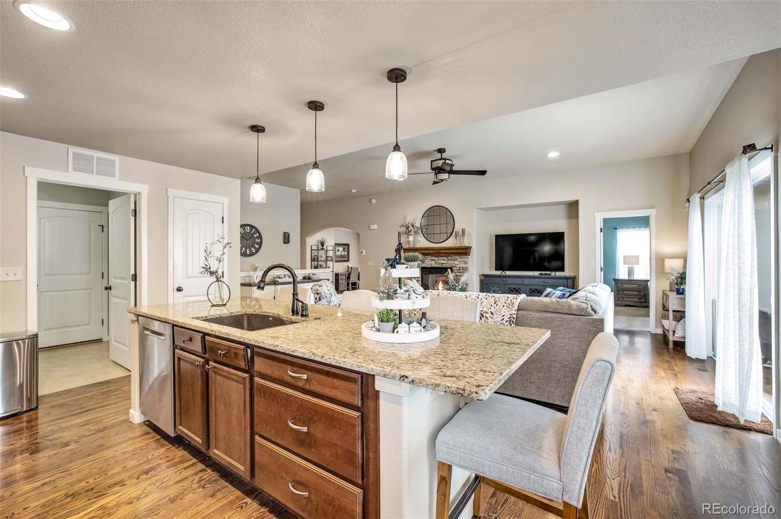 4970 Rabbit Mountain Court Colorado Springs, CO 80924 - Photo 11 of 50 a kitchen with a sink stove and wooden floor