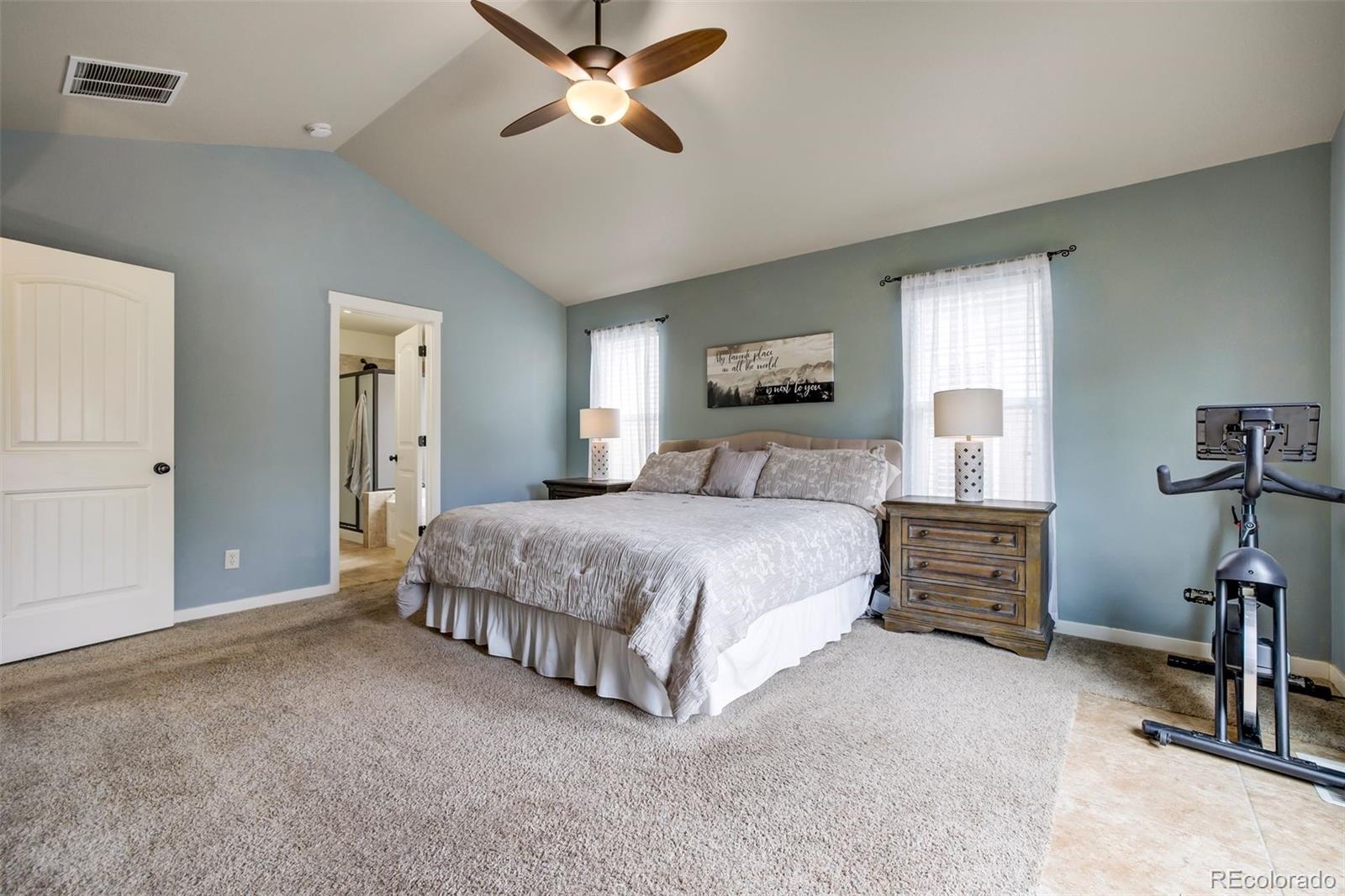 4970 Rabbit Mountain Court Colorado Springs, CO 80924 - Photo 16 of 50 a spacious bedroom with a bed and a chandelier