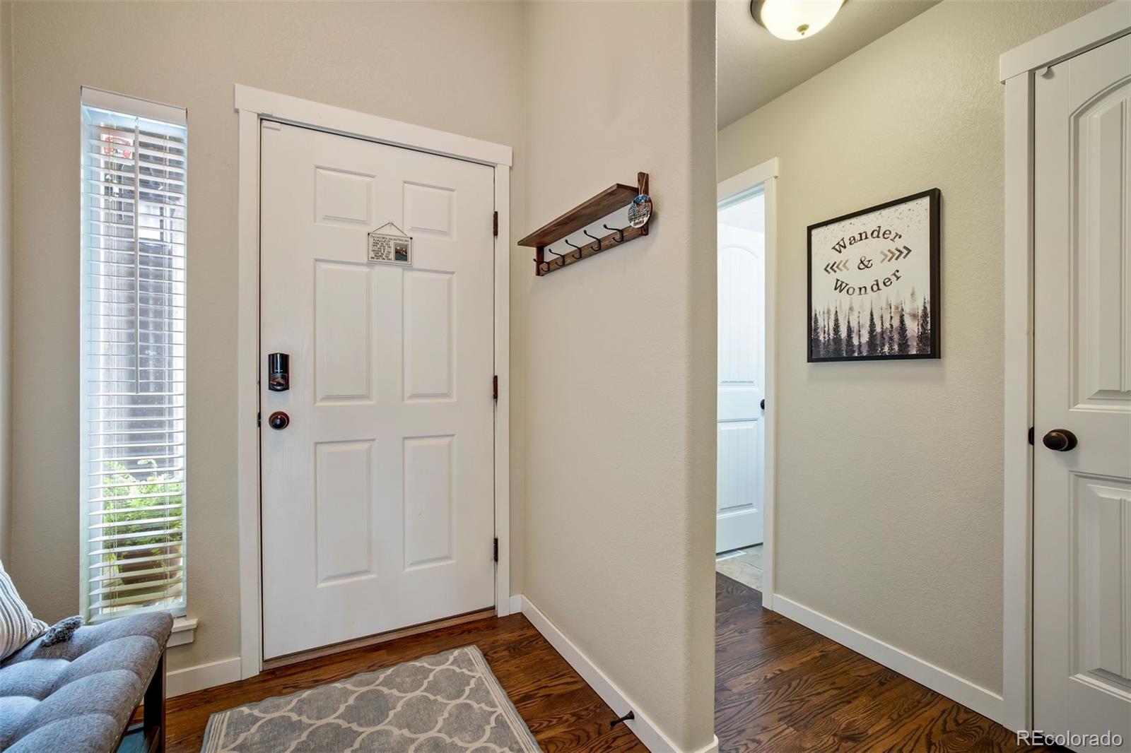 4970 Rabbit Mountain Court Colorado Springs, CO 80924 - Photo 2 of 50 a view of a hallway with wooden floor and windows