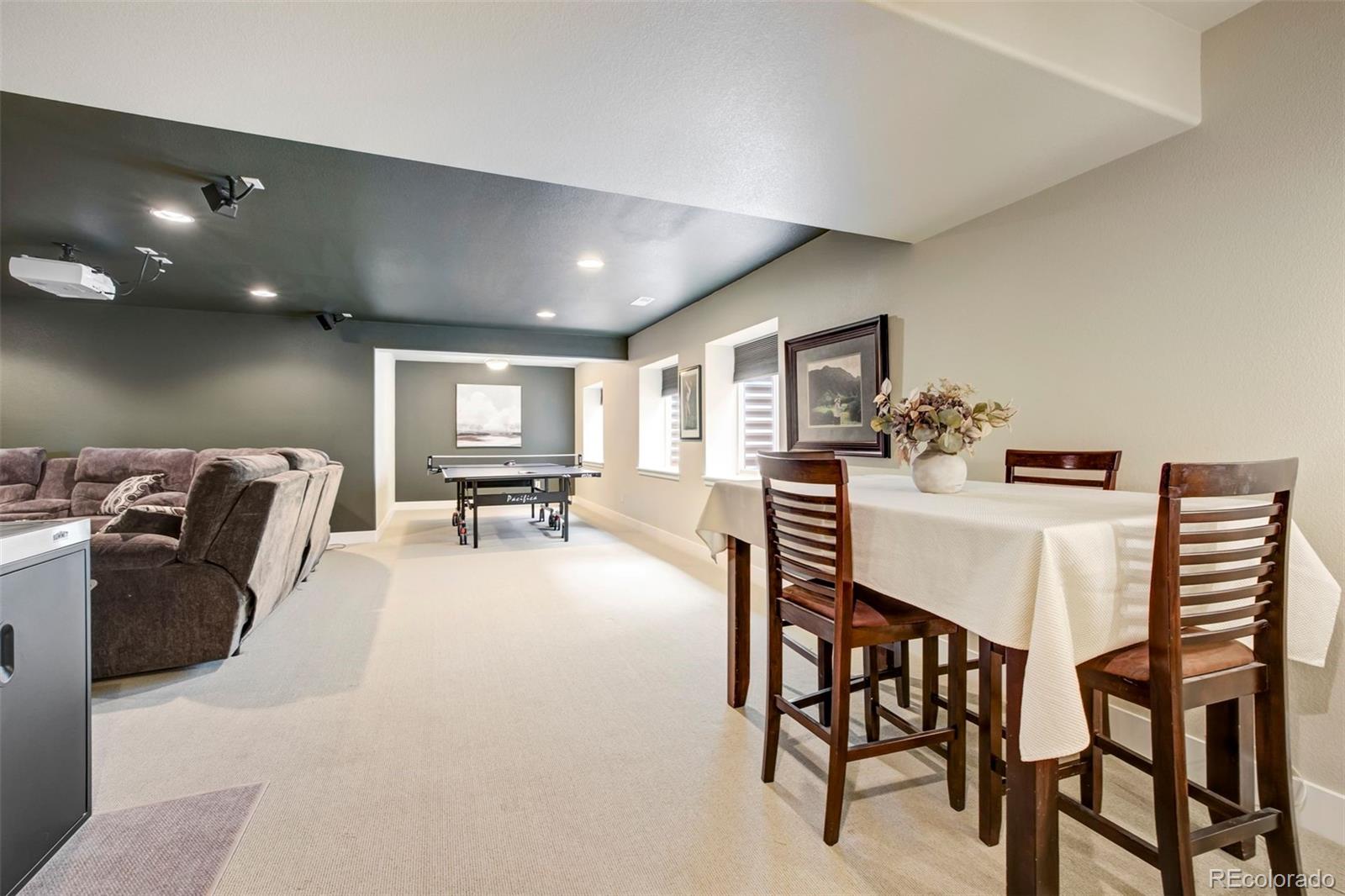 4970 Rabbit Mountain Court Colorado Springs, CO 80924 - Photo 27 of 50 a living room with furniture and kitchen view