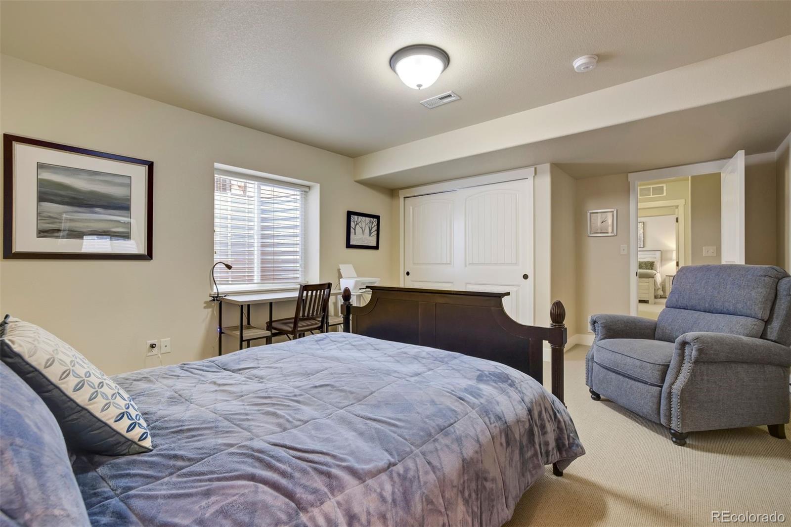 4970 Rabbit Mountain Court Colorado Springs, CO 80924 - Photo 37 of 50 a bedroom with a large bed and a couch