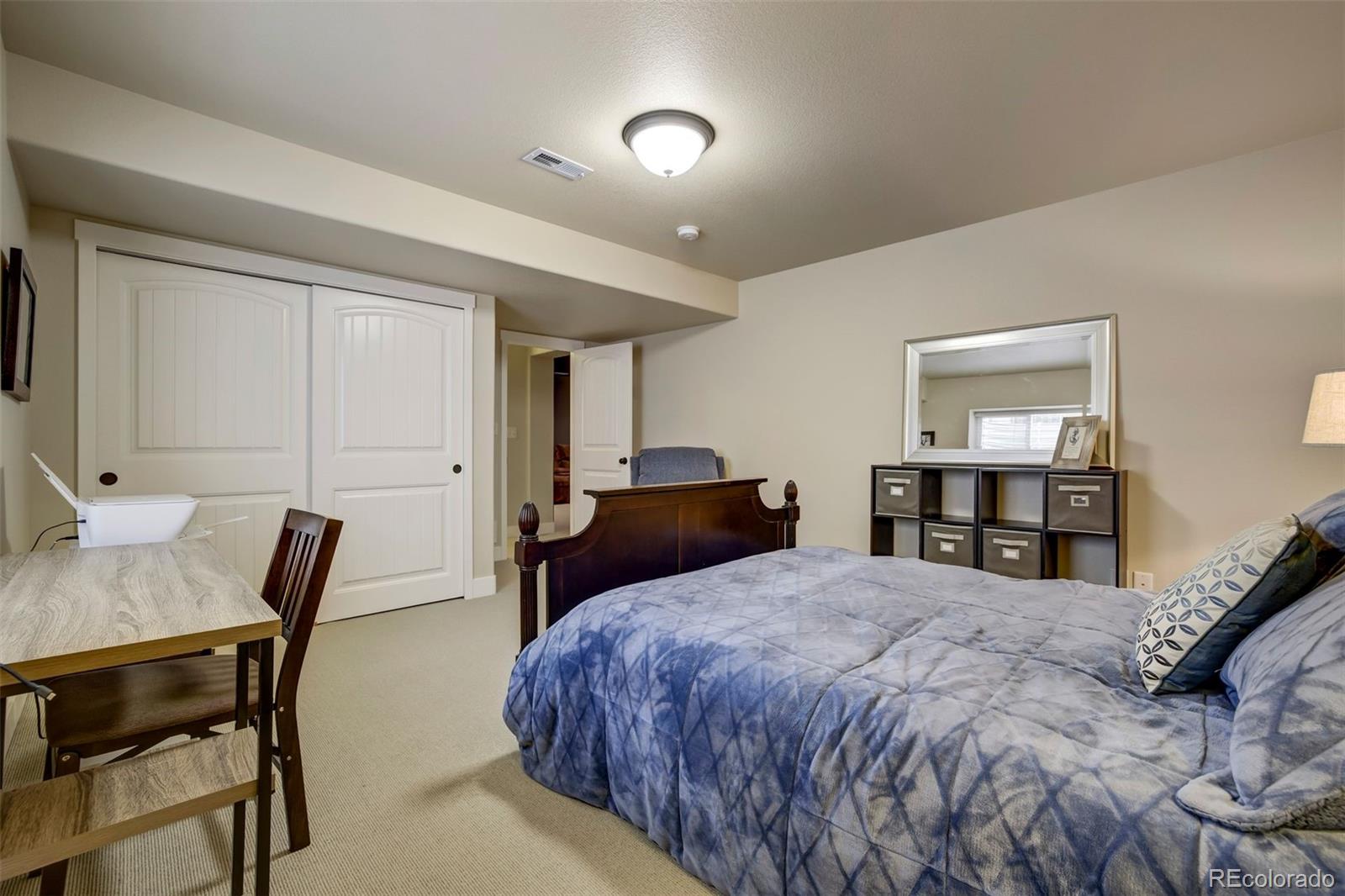 4970 Rabbit Mountain Court Colorado Springs, CO 80924 - Photo 38 of 50 a bedroom with a bed and a table