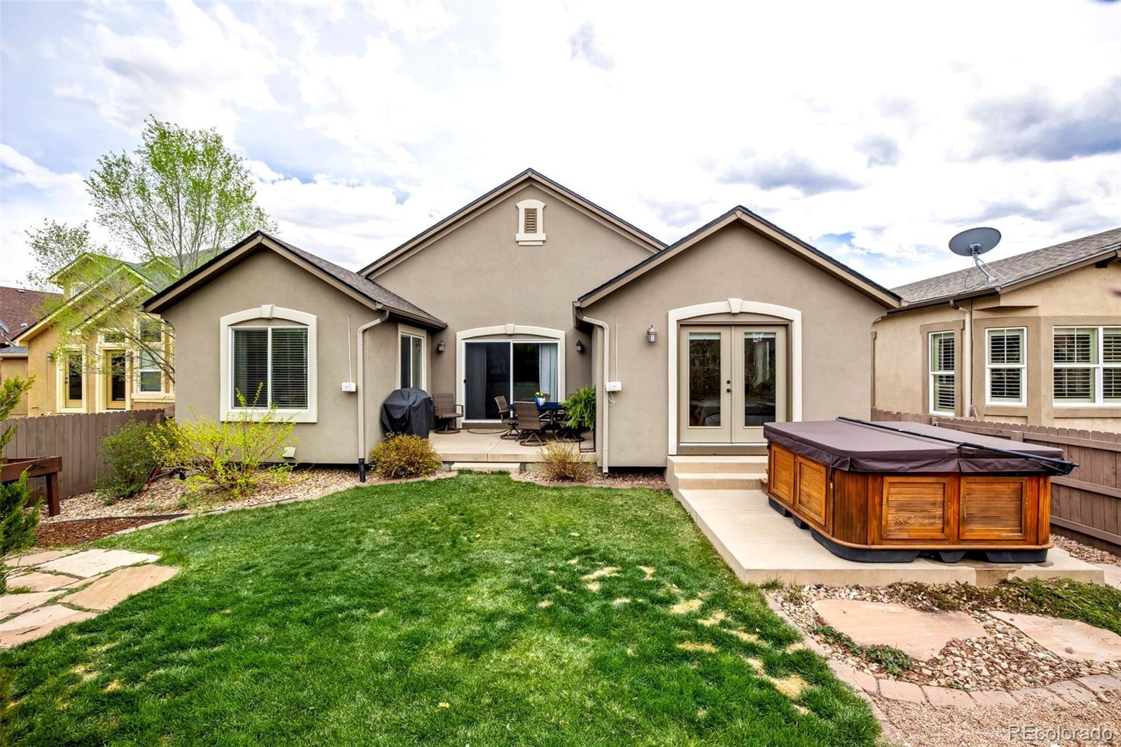 4970 Rabbit Mountain Court Colorado Springs, CO 80924 - Photo 42 of 50 a front view of a house with a yard and porch