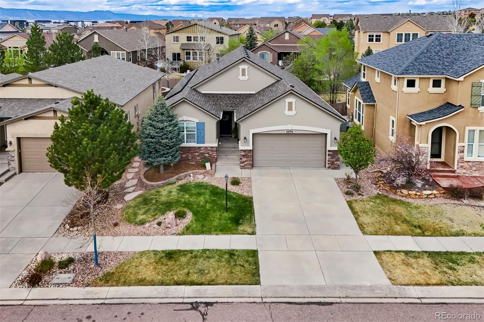 4970 Rabbit Mountain Court Colorado Springs, CO 80924 - Photo 43 of 50 a front view of a house with garden