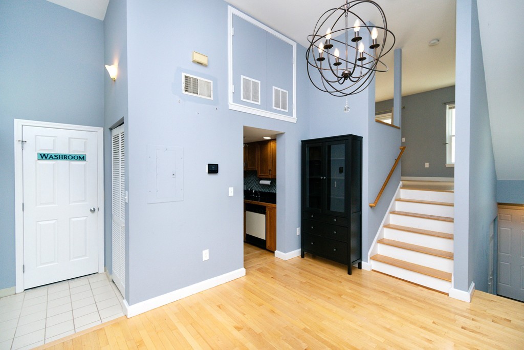 a view of a hallway with entryway closet and a kitchen view
