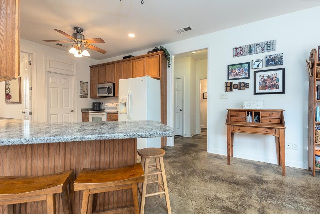 75 Edenberg Drive Collierville, TN 38017 - Photo 25 of 40 a kitchen with kitchen island granite countertop cabinets and refrigerator