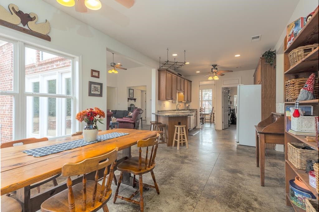 75 Edenberg Drive Collierville, TN 38017 - Photo 33 of 40 a dining hall with stainless steel appliances a dining table chairs and couches