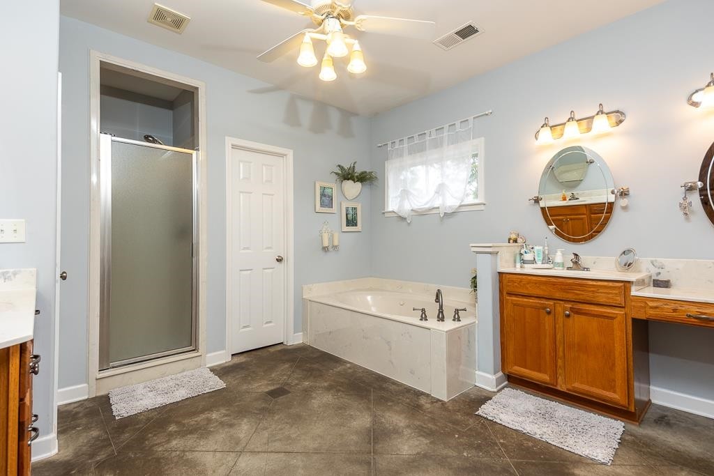 75 Edenberg Drive Collierville, TN 38017 - Photo 37 of 40 a large spacious bathroom with a tub sink and mirror
