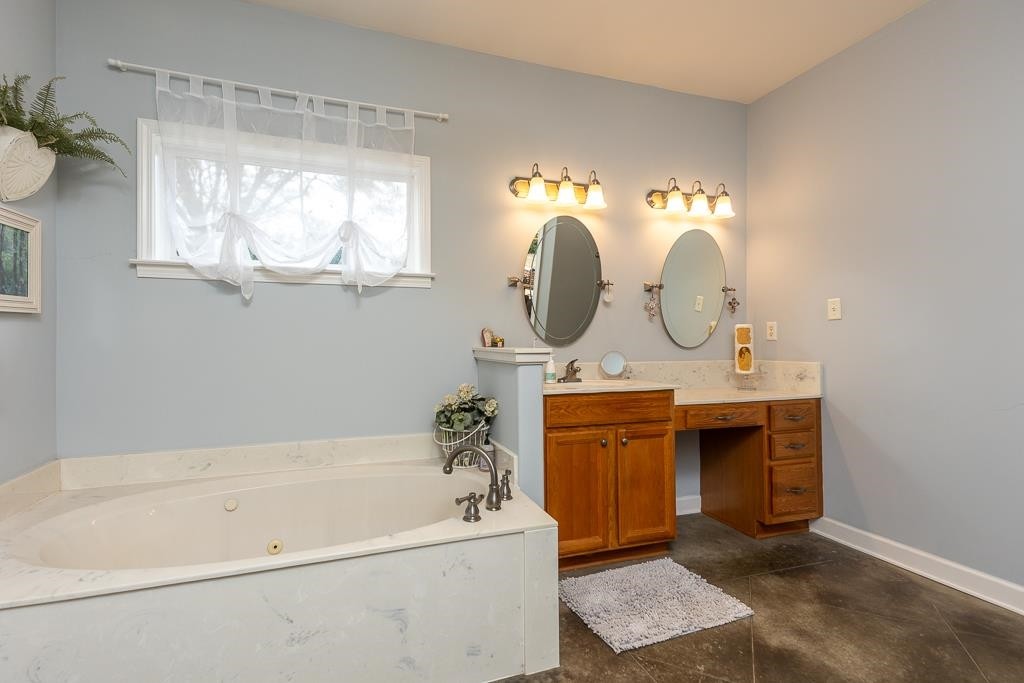 75 Edenberg Drive Collierville, TN 38017 - Photo 39 of 40 a bathroom with a tub sink and mirror