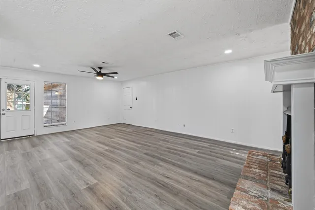 a kitchen with granite countertop white cabinets and stainless steel appliances