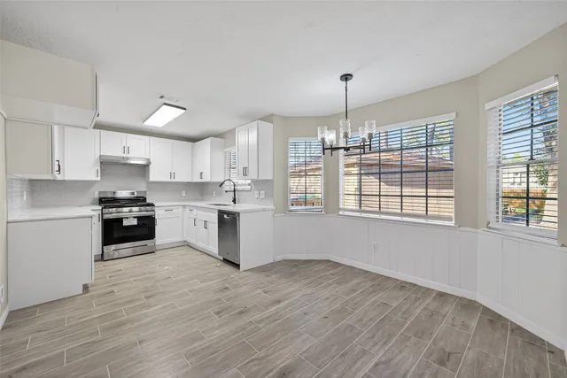 a view of an entryway with wooden floor
