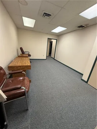 a room with an empty space and a ceiling fan