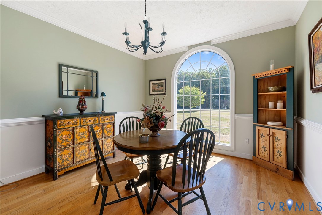 15441 Goshen Road Montpelier, VA 23192 - Photo 22 of 47 a dining room with furniture a window and wooden floor