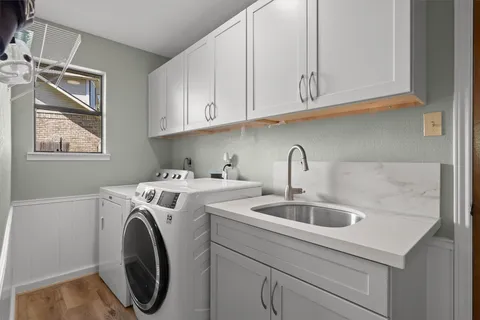 a view of a kitchen sink and a washer dryer