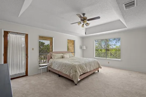 a bedroom with a large bed and a chandelier