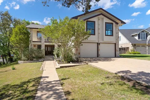 a front view of a house with a yard and garage