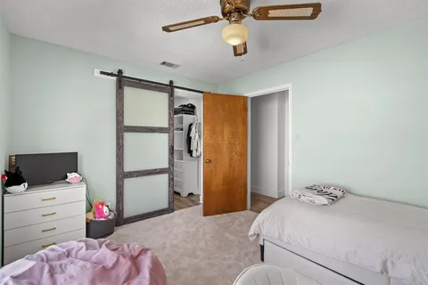 a bedroom with a bed and a chandelier