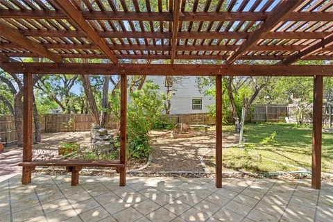a view of a porch with furniture and garden
