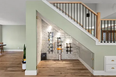 a view of a hallway with wooden floor and stairs