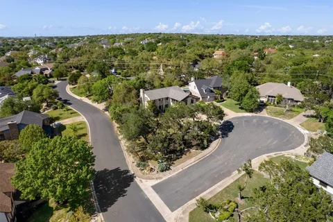 an aerial view of residential houses with outdoor space and street view