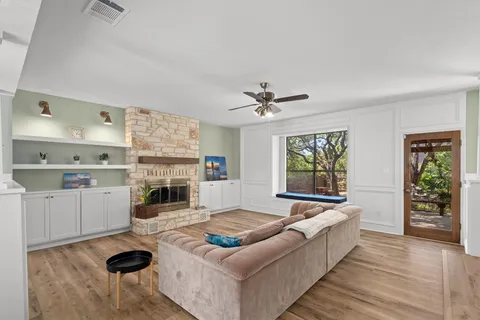 a living room with furniture and a fireplace