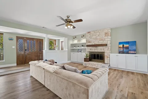 a living room with furniture a fireplace and a flat screen tv