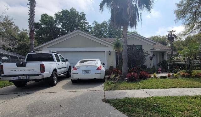 a front view of a house with cars parked