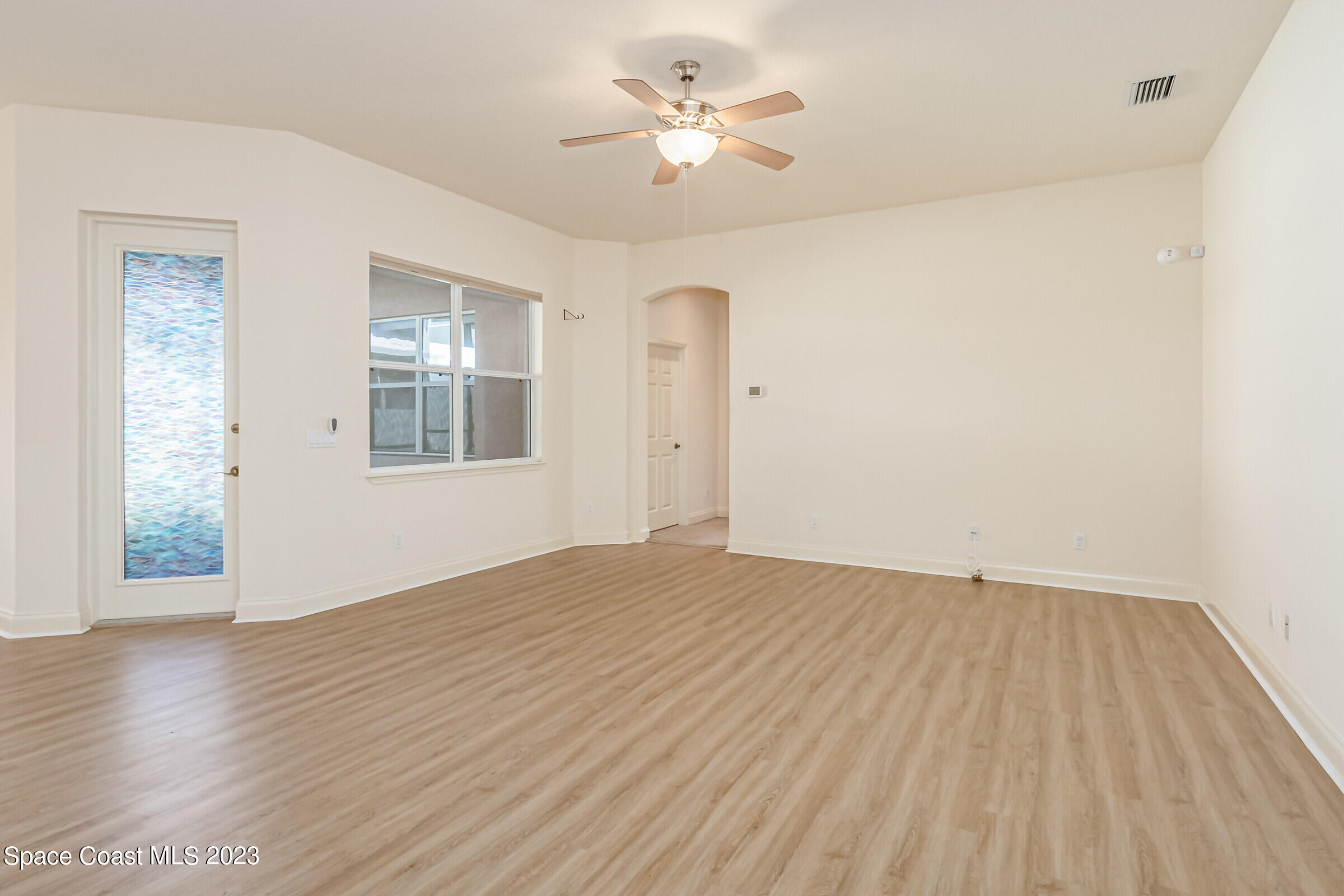 4100 Alamanda Key Drive Melbourne, FL 32901 - Photo 11 of 73 wooden floor in an empty room with a window