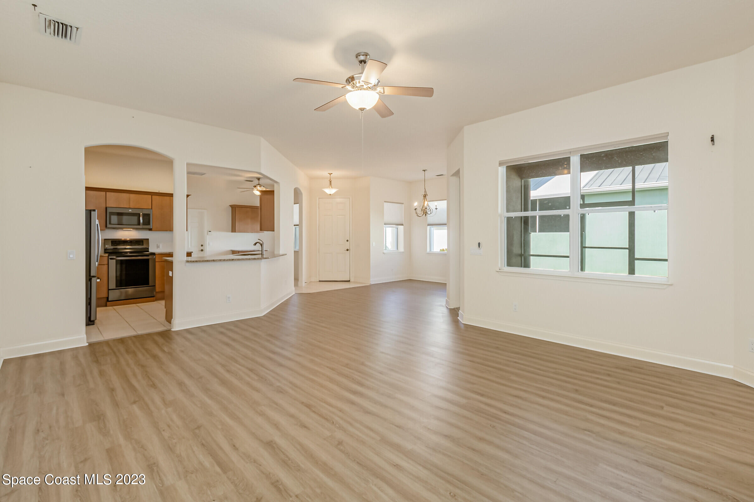4100 Alamanda Key Drive Melbourne, FL 32901 - Photo 13 of 73 a view of an empty room with window and wooden floor