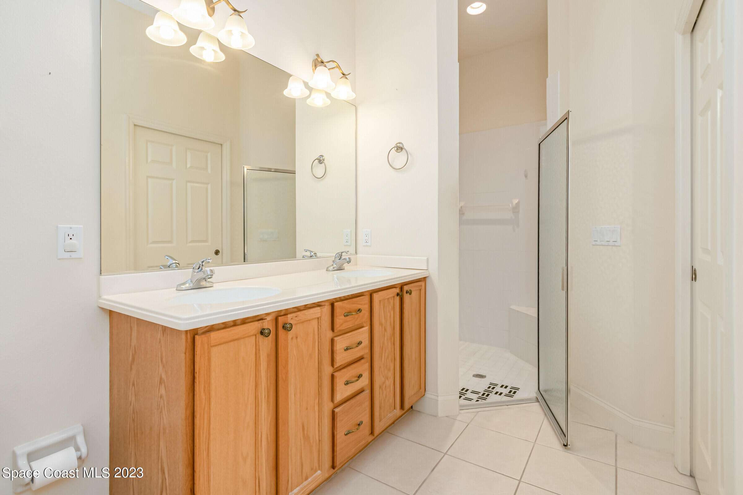 4100 Alamanda Key Drive Melbourne, FL 32901 - Photo 19 of 73 a bathroom with a sink and a mirror