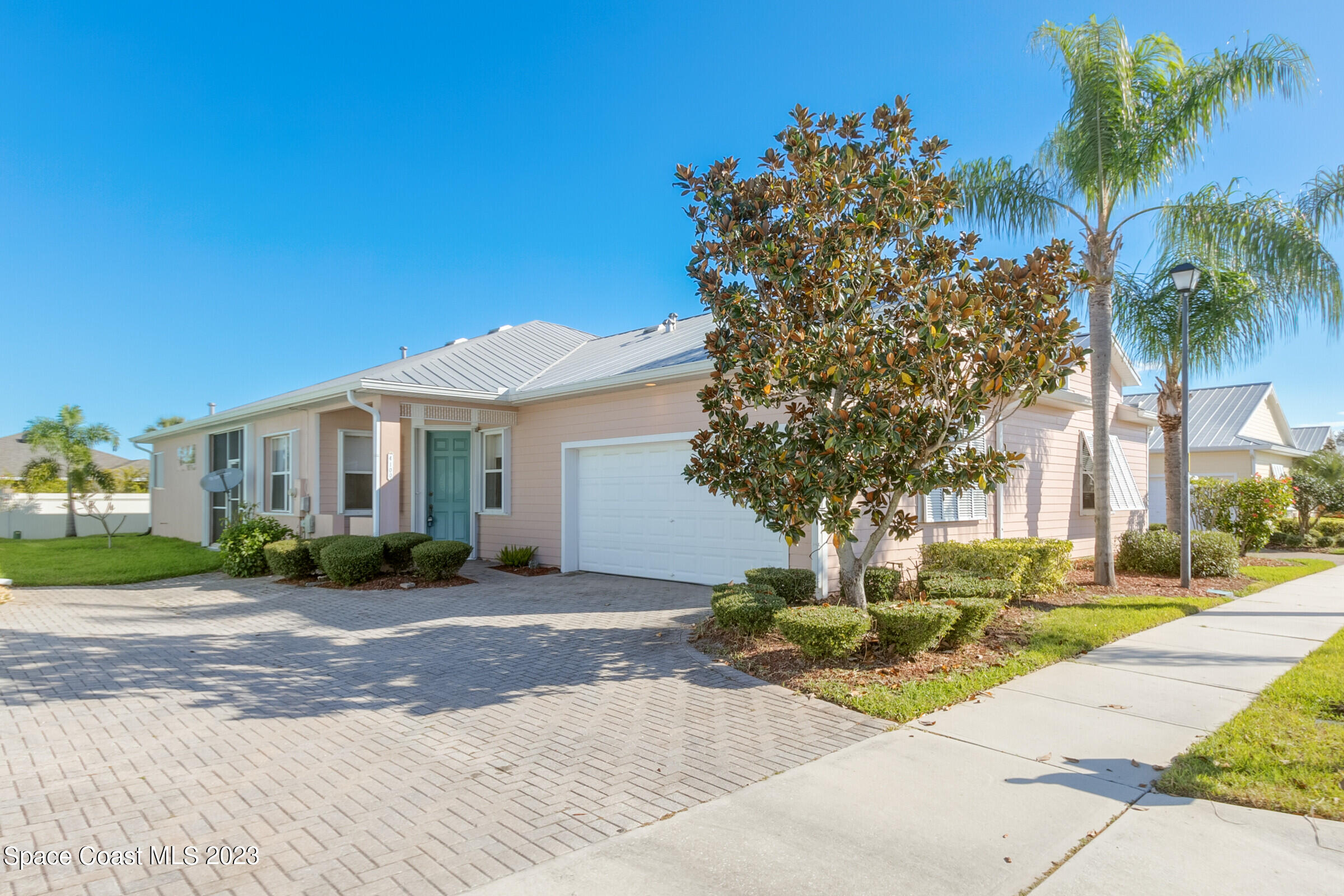 4100 Alamanda Key Drive Melbourne, FL 32901 - Photo 2 of 73 a front view of a house with a yard and potted plants