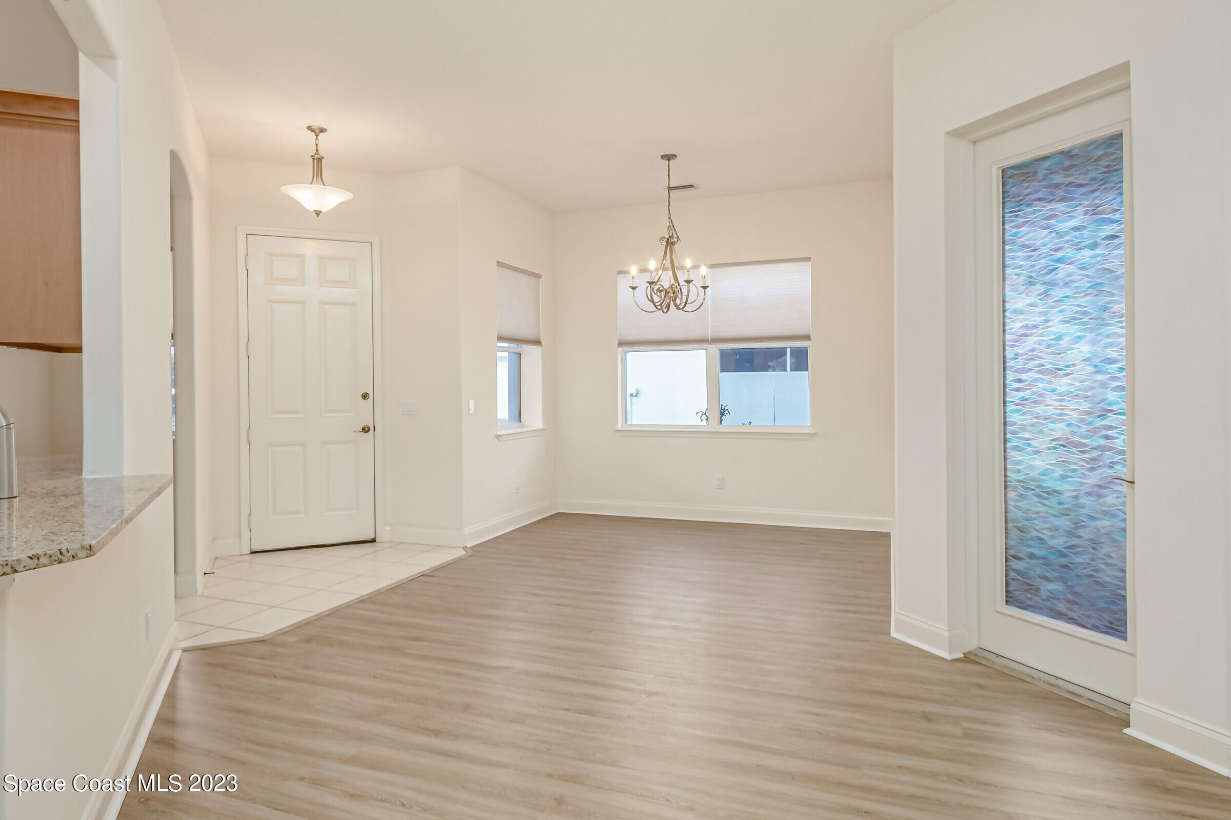4100 Alamanda Key Drive Melbourne, FL 32901 - Photo 26 of 73 an empty room with wooden floor and windows