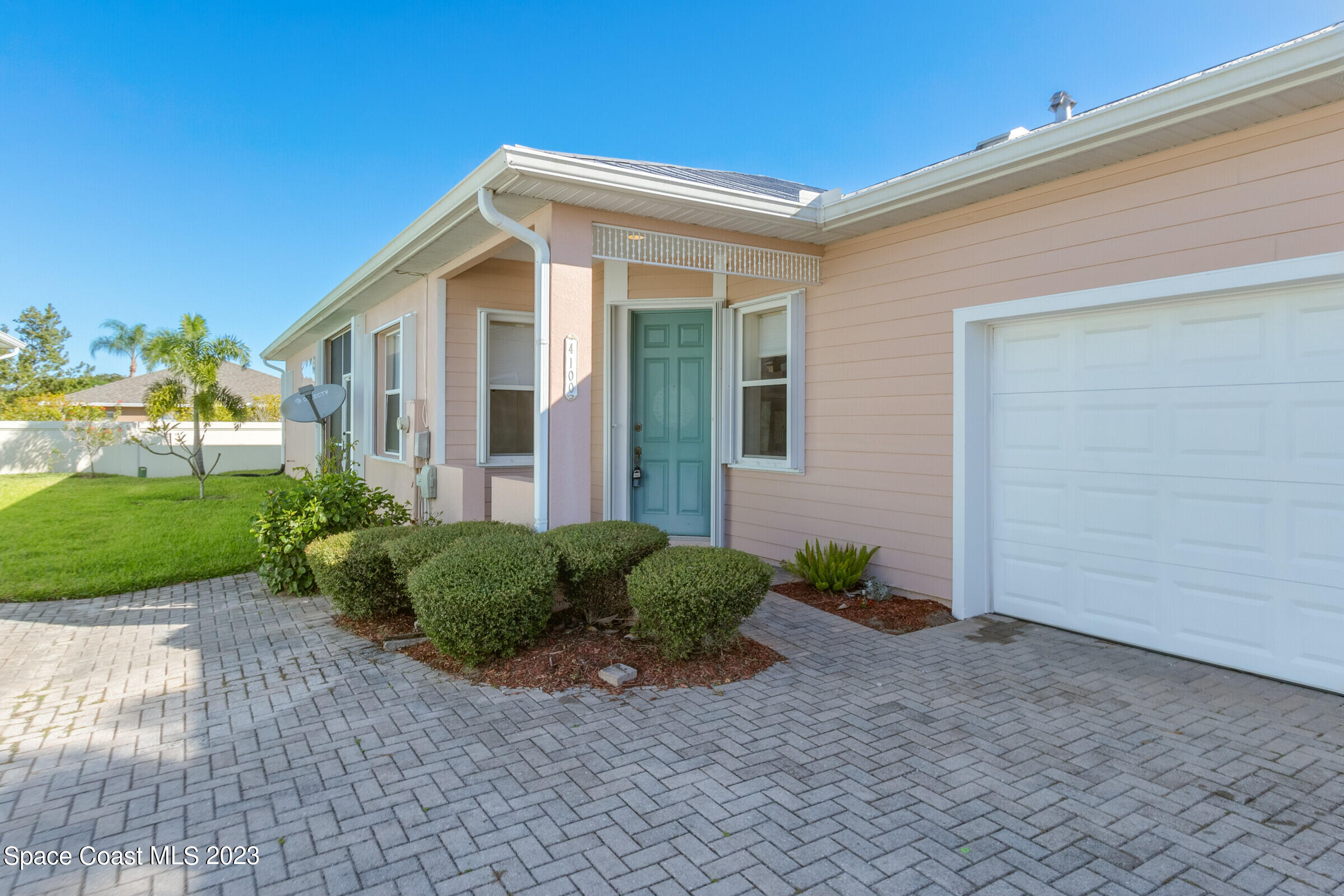 4100 Alamanda Key Drive Melbourne, FL 32901 - Photo 32 of 73 a front view of a house with garden
