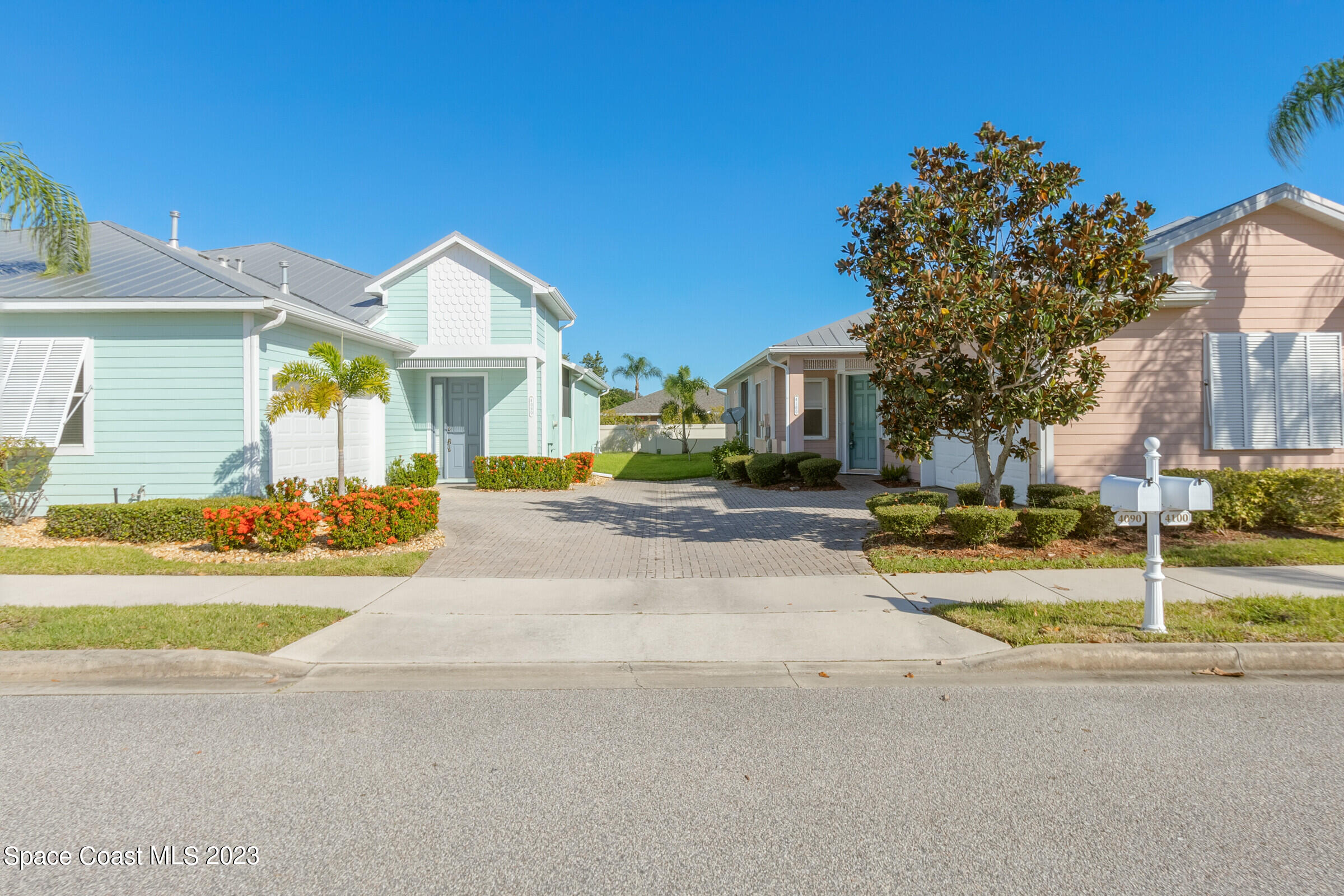 4100 Alamanda Key Drive Melbourne, FL 32901 - Photo 33 of 73 a view of a white house with a large tree and plants