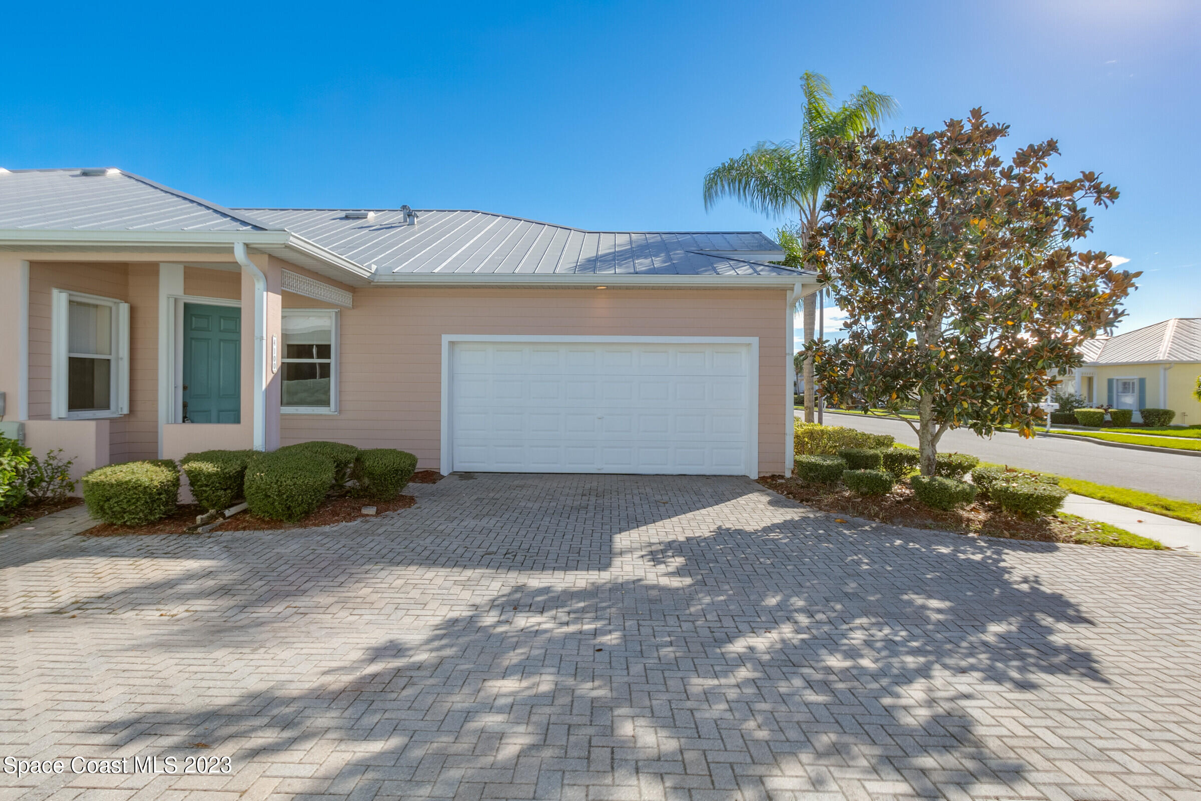 4100 Alamanda Key Drive Melbourne, FL 32901 - Photo 36 of 73 a front view of a house with a yard and garage